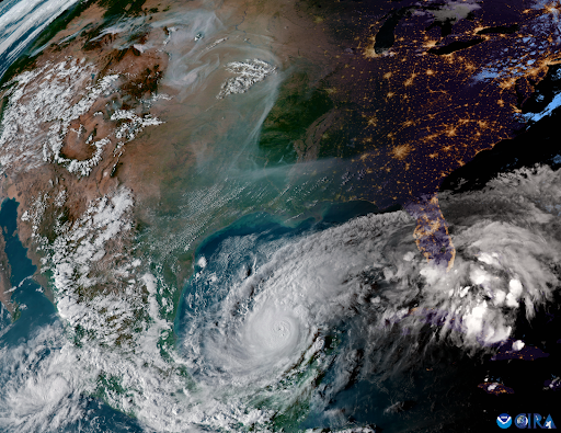 A satellite view of North America on October 7, 2024, showing wildfire smoke from the west snaking across the middle of the continent, and a Category 5 Hurricane Milton churning in the Gulf of Mexico.