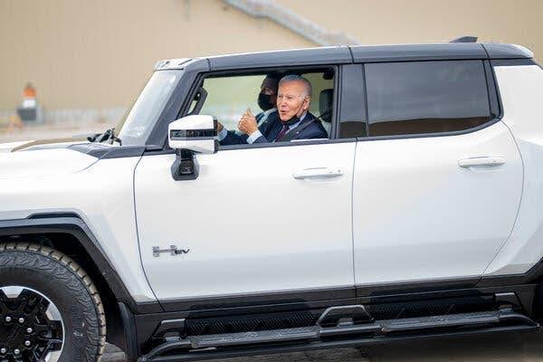 biden giving thumbs up in vehicle