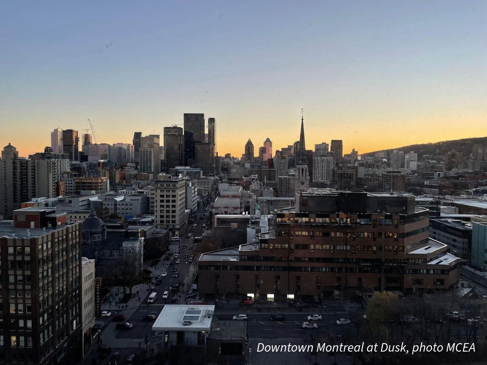 a downtown scene with many buildings and sun setting