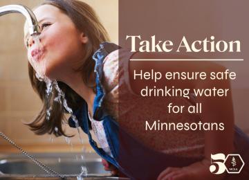 a white child drinking from a faucet