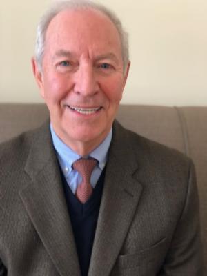 a photo of a smiling white man in a tie