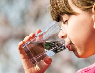 a white child drinking water