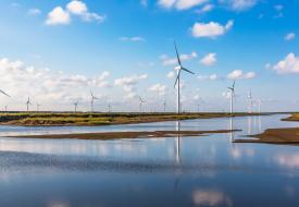 wind turbines blue sky water