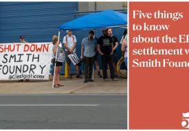 a crowd standing with a sign that says shut down smith foundry