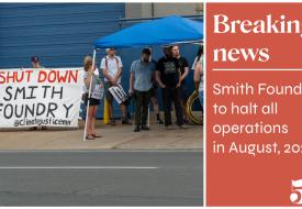 words: breaking news smith foundry closing with a group of people holding signs outside a building